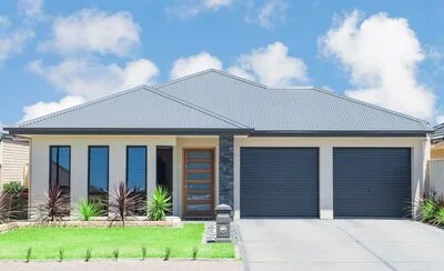 Modern home with a light-colored metal roof and double garage
